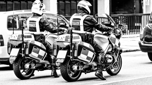 Two Police motorcycles in traffic